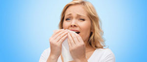 unhappy-woman-with-napkin-sneezing